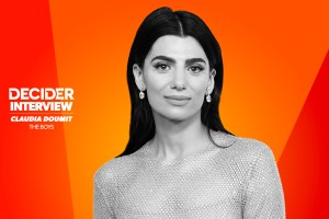 Claudia Doumit in black and white on a bright orange background